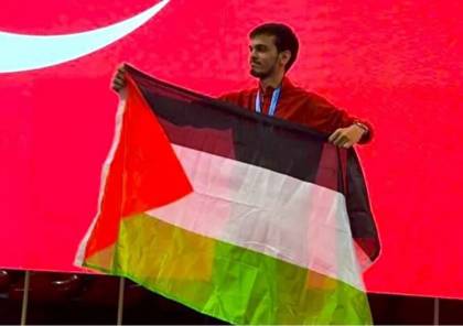 البطل التركي أثناء رفعه العلم &nbsp;الفلسطيني