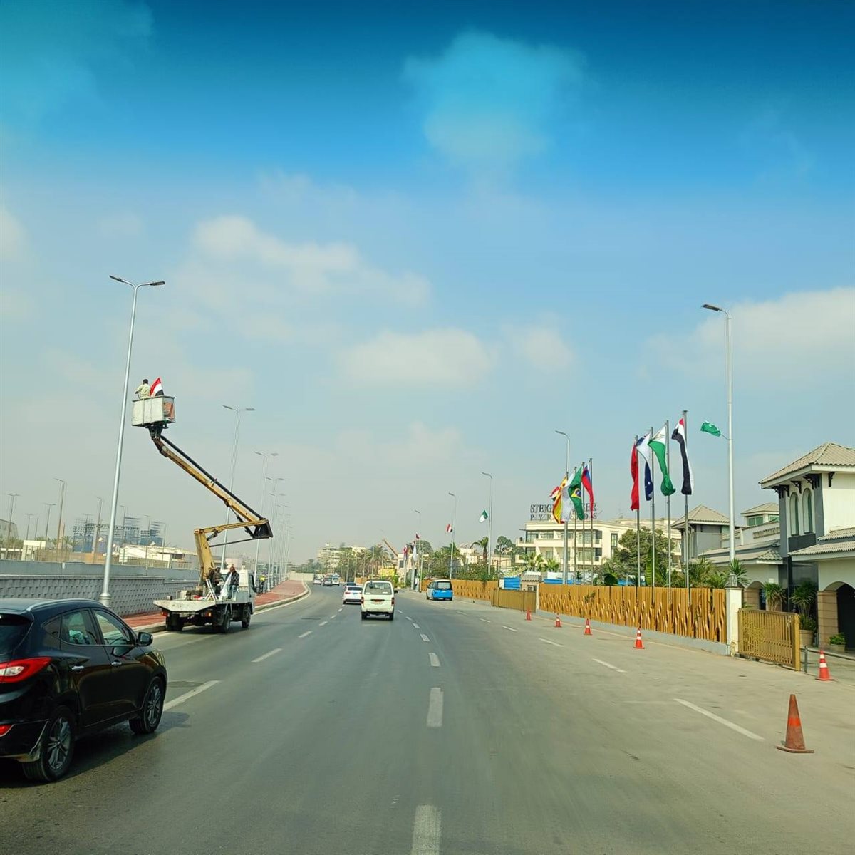 تعليق أعلام ولافتات ترحيبية بالضيوف على الطرق المؤدية للمتحف المصري الكبير